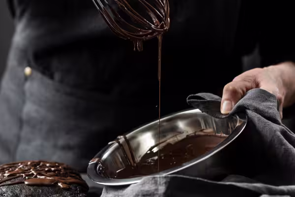 chocolate dripping from whisk into bowl